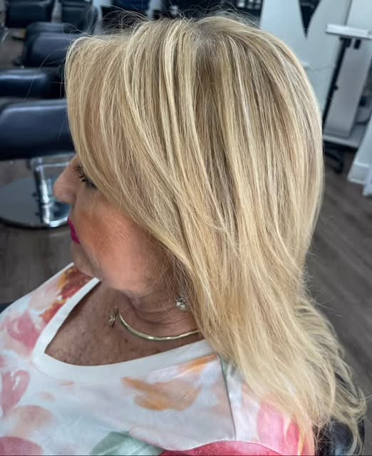 Golden blonde highlights on a layered, side-swept style