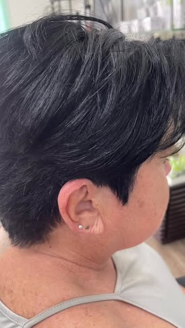 Short, textured pixie cut on dark hair